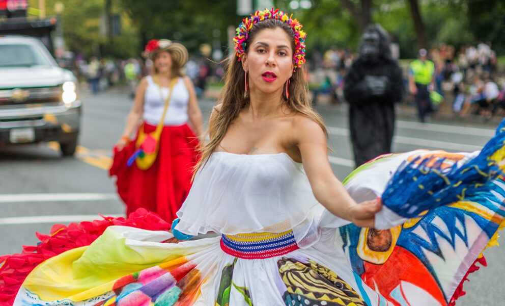 Woman in colorful folk costume dancing at parade