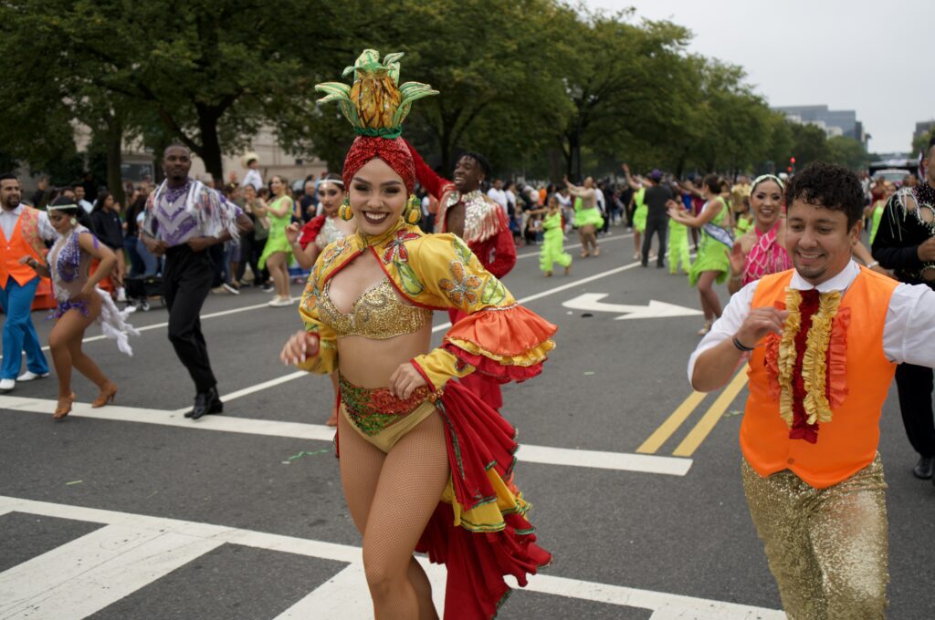 Colorful carnival dancers performing on city street