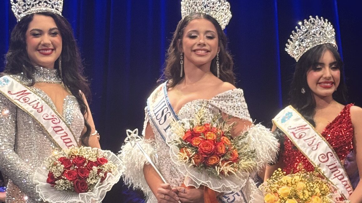 Crowned winners celebrating with flowers
